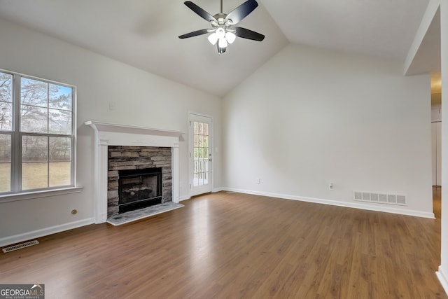 unfurnished living room featuring a fireplace, ceiling fan, hardwood / wood-style floors, and lofted ceiling