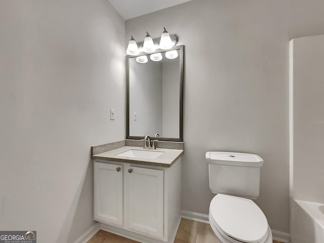 bathroom with tile patterned flooring, vanity, and toilet