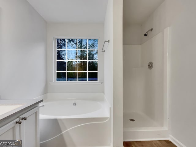 bathroom featuring vanity, wood-type flooring, and independent shower and bath