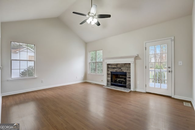 unfurnished living room featuring plenty of natural light and dark wood-type flooring