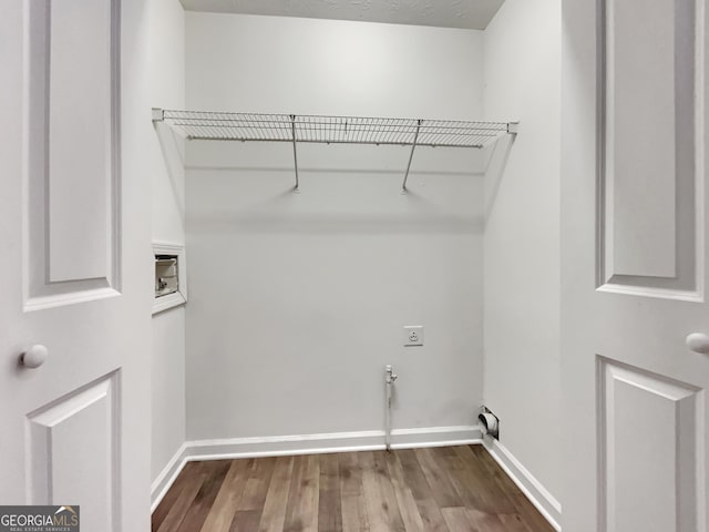 laundry room featuring hookup for an electric dryer, wood-type flooring, hookup for a gas dryer, and washer hookup