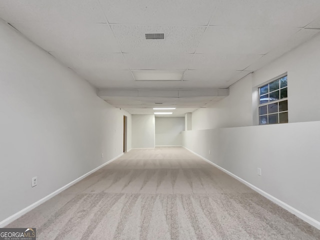 spare room featuring light carpet