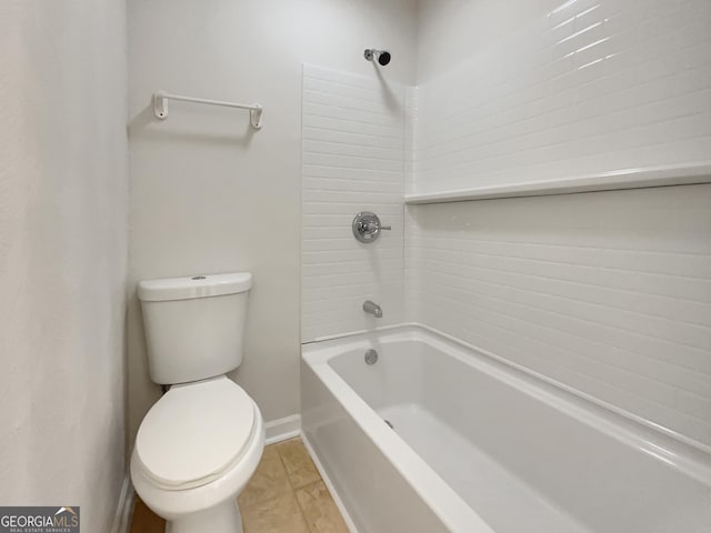 bathroom with tile patterned floors, shower / bath combination, and toilet