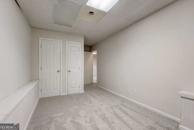 unfurnished bedroom featuring light carpet