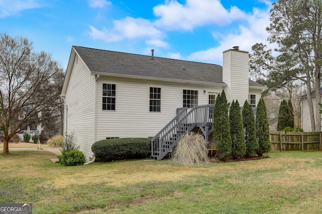 back of property with a lawn