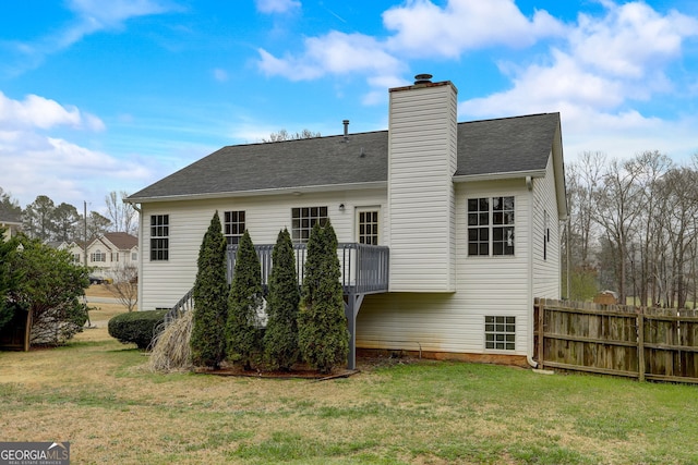 rear view of property featuring a lawn