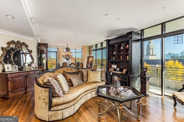 living room with floor to ceiling windows, dark wood-type flooring, a notable chandelier, and ornamental molding