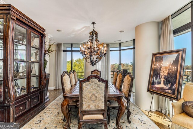 750 Park Ave NE Unit 8E, Atlanta, GA 30326 - dining room with a chandelier, wood finished floors, and a wall of windows
