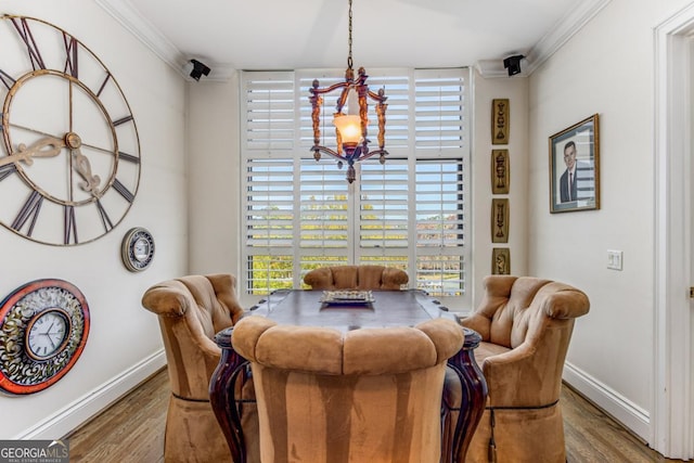 750 Park Ave NE Unit 8E, Atlanta, GA 30326 - dining room with crown molding, wood finished floors, baseboards, and a chandelier
