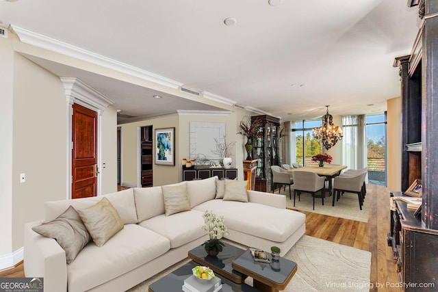 750 Park Ave NE Unit 8E, Atlanta, GA 30326 - living room featuring light wood-type flooring, a chandelier, ornamental molding, and recessed lighting