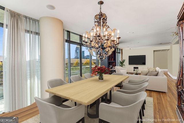 750 Park Ave NE Unit 8E, Atlanta, GA 30326 - dining space featuring a chandelier and light wood-style floors