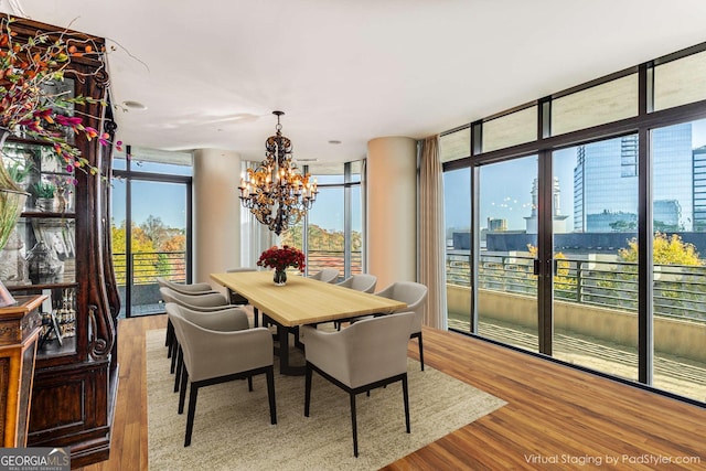 750 Park Ave NE Unit 8E, Atlanta, GA 30326 - dining room with a chandelier, wood finished floors, and plenty of natural light