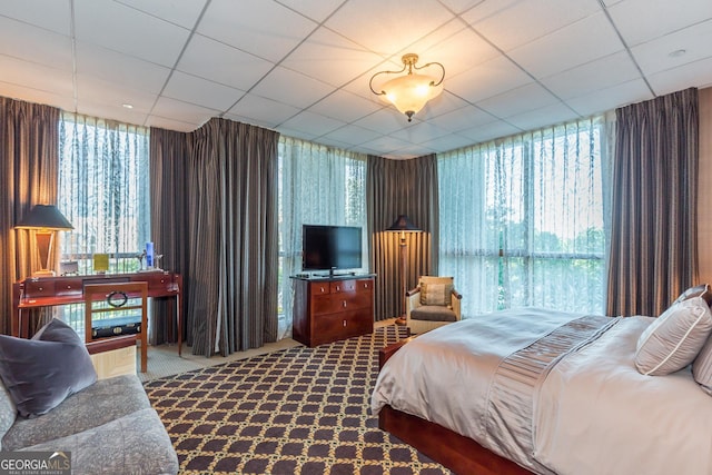 750 Park Ave NE Unit 8E, Atlanta, GA 30326 - bedroom featuring multiple windows, carpet floors, and a paneled ceiling