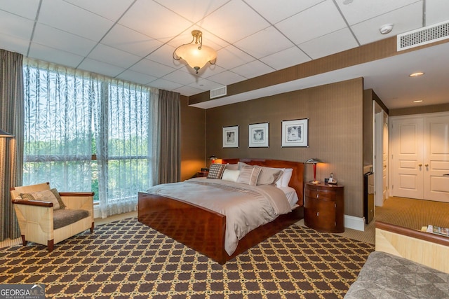 750 Park Ave NE Unit 8E, Atlanta, GA 30326 - bedroom with carpet flooring, multiple windows, baseboards, and a paneled ceiling