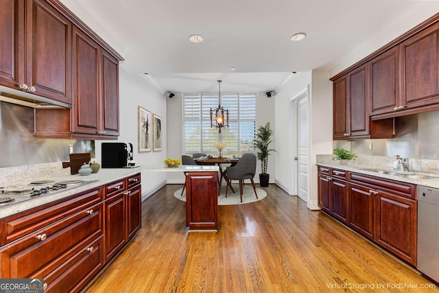 750 Park Ave NE Unit 8E, Atlanta, GA 30326 - kitchen featuring stainless steel dishwasher, wood finished floors, dark brown cabinets, electric stovetop, and hanging light fixtures