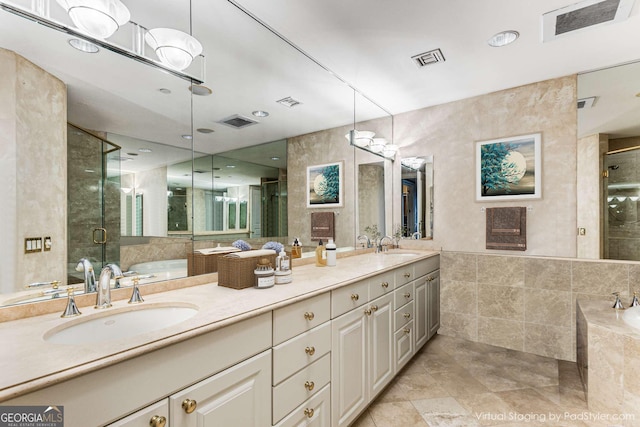 750 Park Ave NE Unit 8E, Atlanta, GA 30326 - full bath featuring tile walls, a stall shower, a bath, double vanity, and tile patterned floors