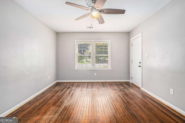 unfurnished room featuring ceiling fan and dark hardwood / wood-style flooring