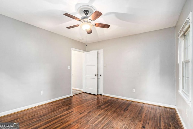 empty room featuring dark hardwood / wood-style flooring and ceiling fan