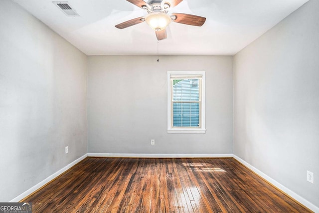 empty room with ceiling fan and dark wood-type flooring