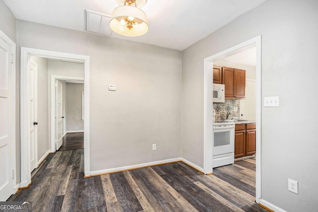 unfurnished dining area with dark hardwood / wood-style floors