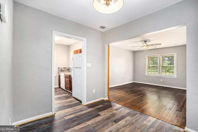 spare room featuring ceiling fan and dark hardwood / wood-style floors