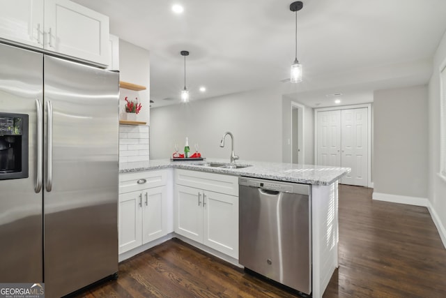 kitchen featuring white cabinets, stainless steel appliances, kitchen peninsula, and sink