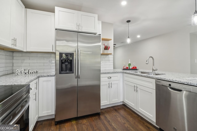 kitchen with white cabinets, sink, dark hardwood / wood-style floors, decorative light fixtures, and stainless steel appliances