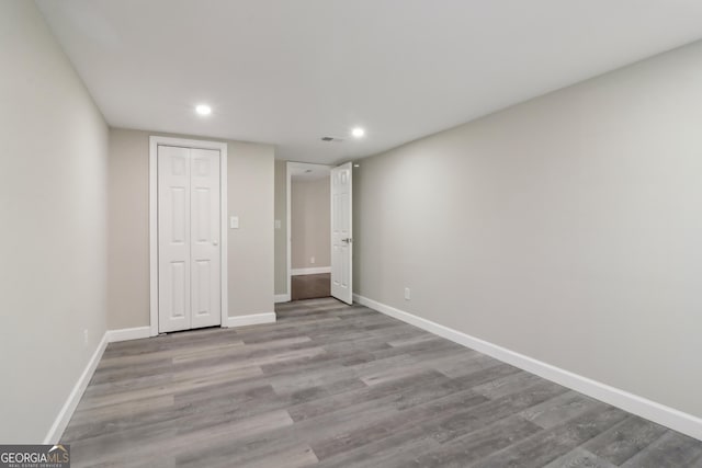 unfurnished bedroom featuring a closet and light wood-type flooring