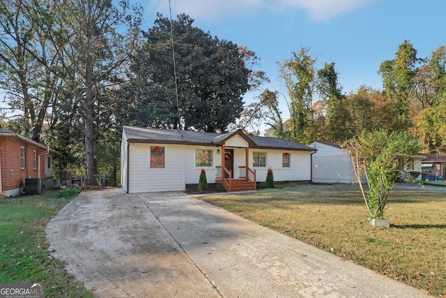 ranch-style house featuring central AC and a front lawn