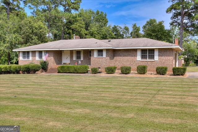 ranch-style home featuring a front yard