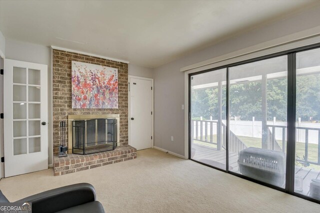 unfurnished living room with carpet flooring and a brick fireplace