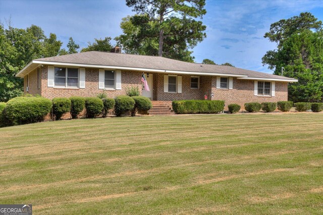 ranch-style home with a front lawn