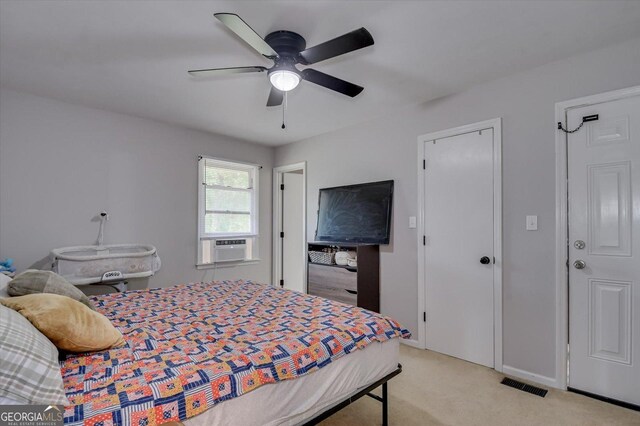 bedroom featuring ceiling fan, cooling unit, and light carpet