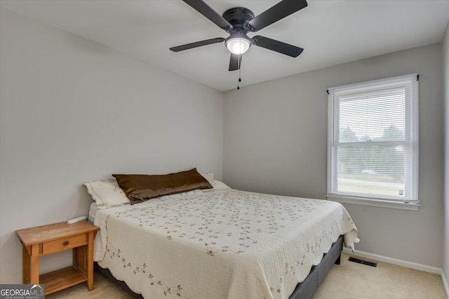 bedroom with ceiling fan and light colored carpet