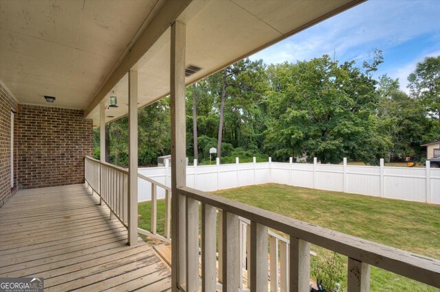 wooden terrace with a yard