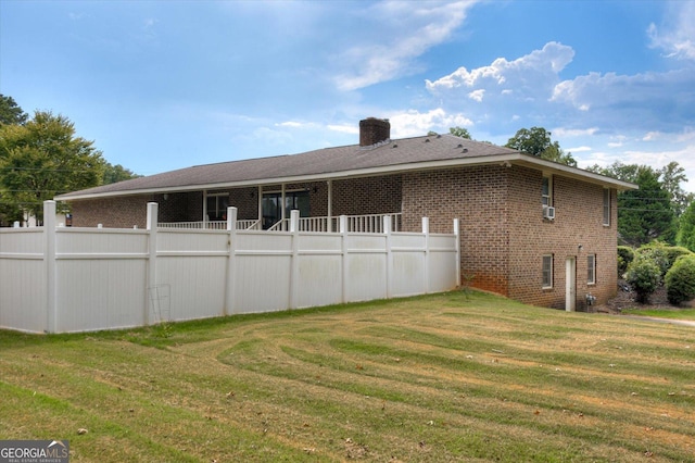 back of property featuring a yard