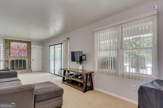 living room with a fireplace, carpet floors, and a healthy amount of sunlight