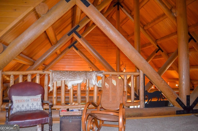 sitting room featuring lofted ceiling with beams, wood walls, and wood ceiling