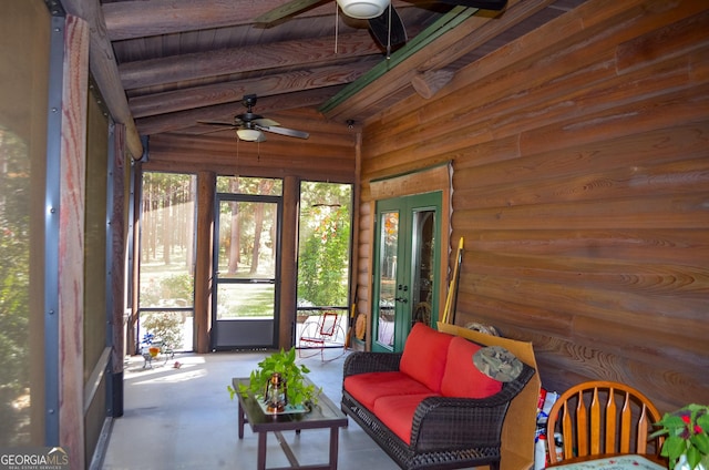 unfurnished sunroom featuring vaulted ceiling and ceiling fan