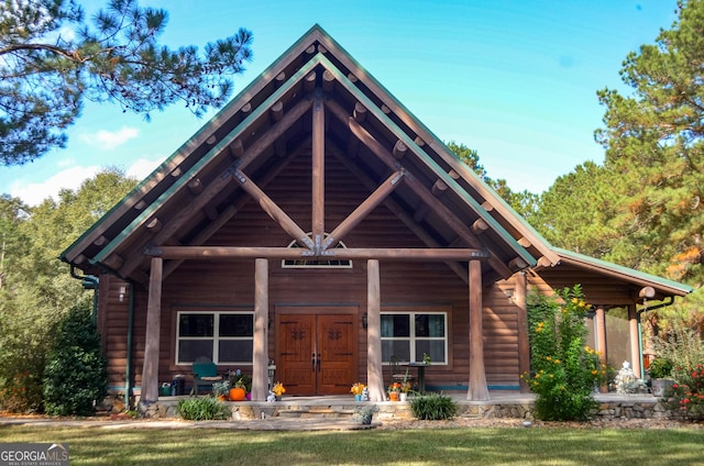 view of front of home featuring a porch and a front lawn