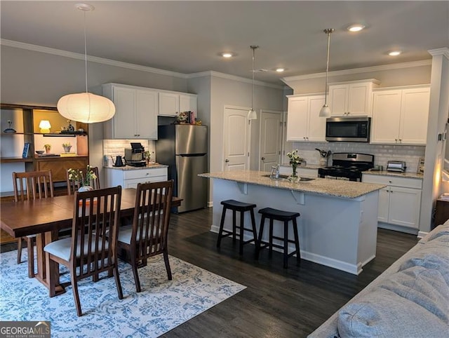 dining room with dark hardwood / wood-style floors, ornamental molding, and sink