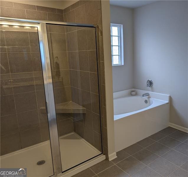 bathroom with tile patterned flooring and separate shower and tub