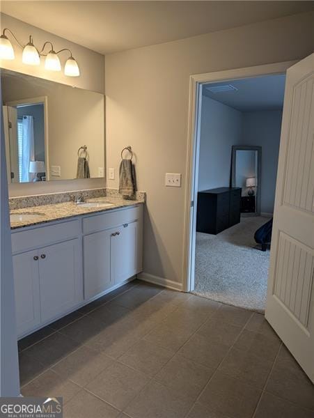 bathroom with tile patterned floors and vanity