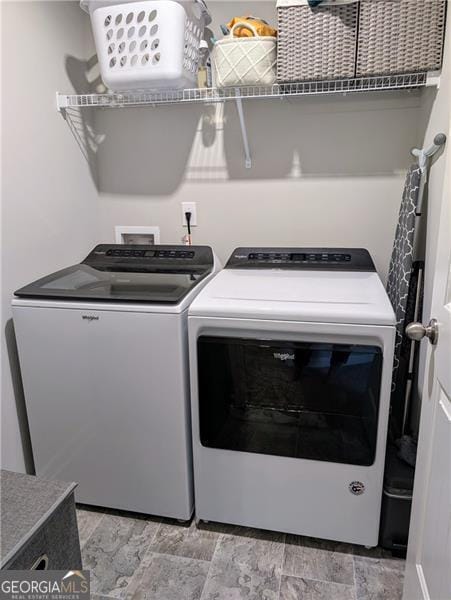 clothes washing area with separate washer and dryer