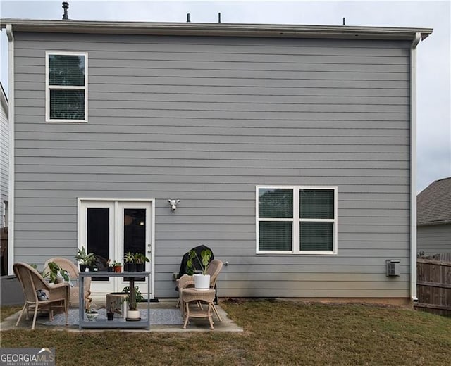 rear view of property with a patio area and a yard