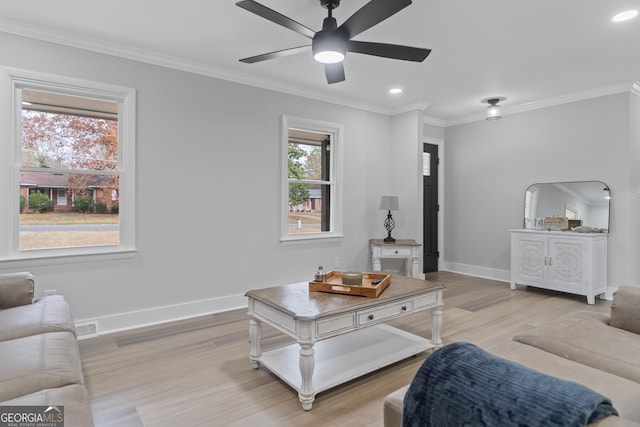 living room with ceiling fan, light hardwood / wood-style floors, and crown molding