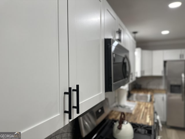 kitchen with stainless steel appliances and white cabinetry