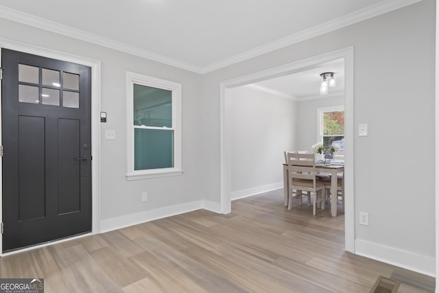 entrance foyer featuring crown molding and light hardwood / wood-style flooring