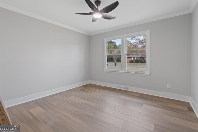 spare room featuring light hardwood / wood-style floors, ceiling fan, and crown molding