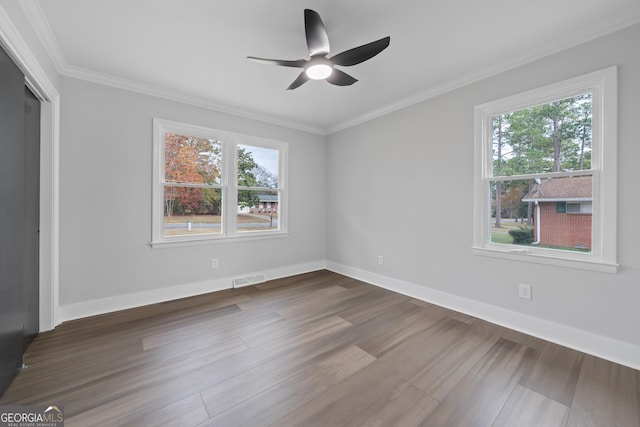 unfurnished room featuring ceiling fan, wood-type flooring, and crown molding